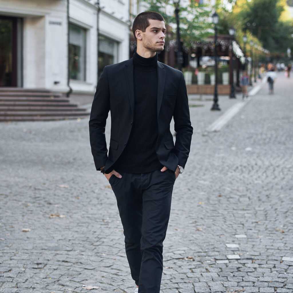 Young man walking, smart casual on an autumn day on a street of European City. Lifestyle Photography